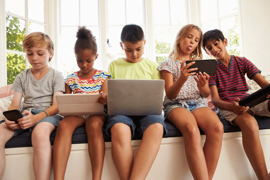 Group of kids reading on their electronic devices